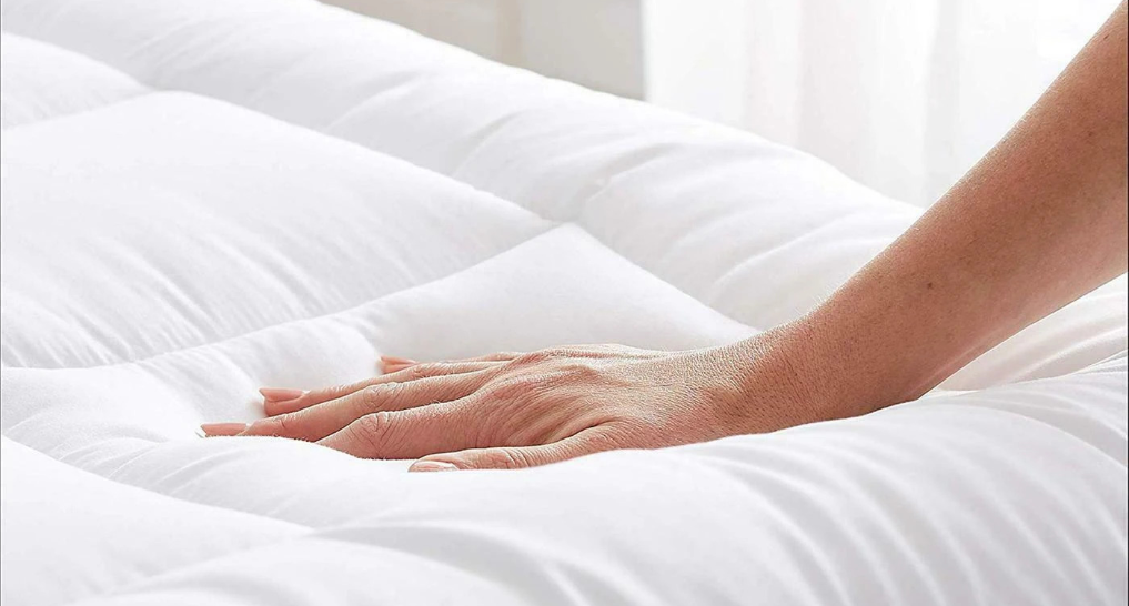 someone putting a mattress cover on