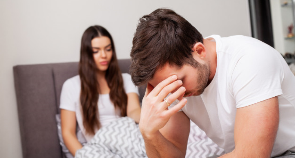 Unhappy couple on bed