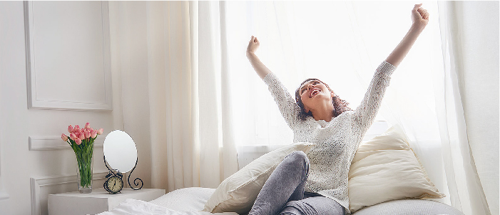 woman waking up happily