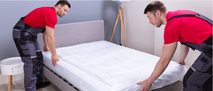 people setting up a mattress